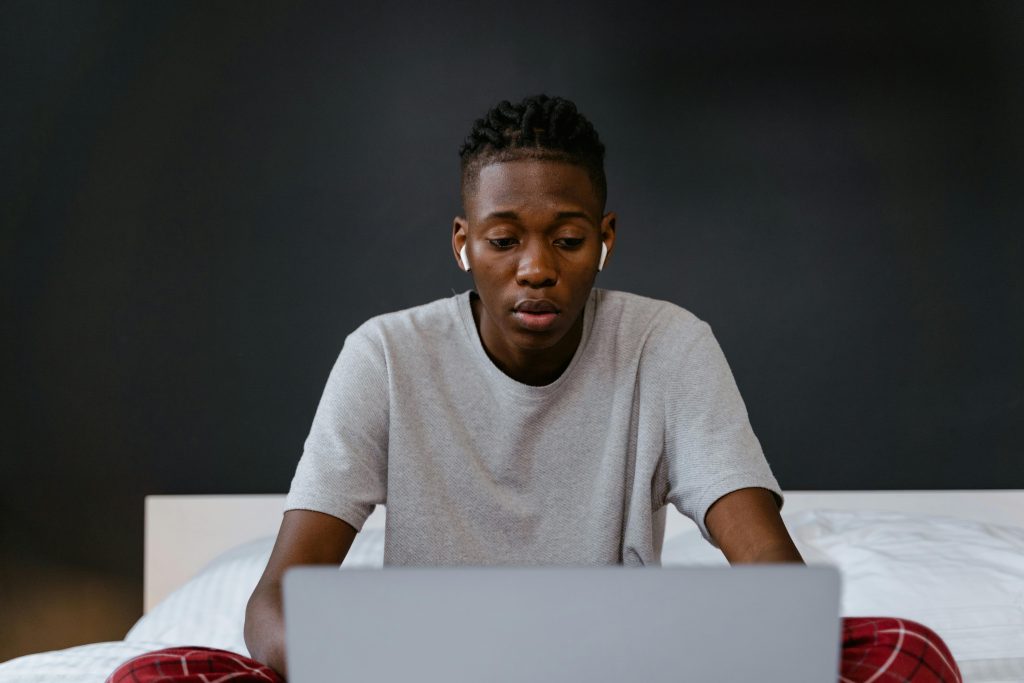 A person focused on their work, wearing noise-canceling headphones