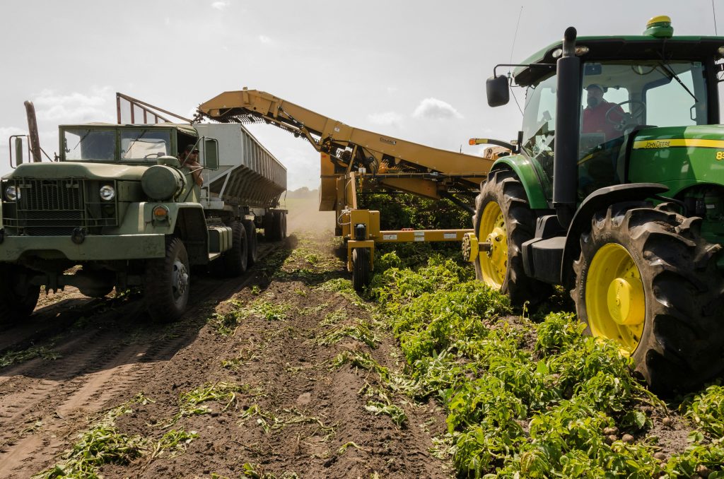 A large automated tractor plowing a field, demonstrating the use of machines in farming