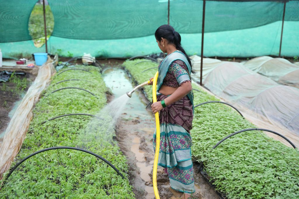 A smart irrigation system sprinkling water over crops in a field, conserving water through automation