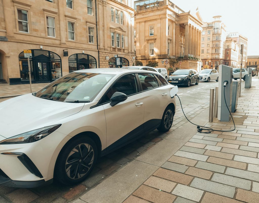 Electric car charging at a station, showing green transportation tech