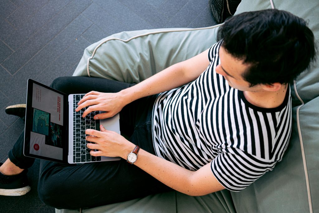 A man blogging on his couch